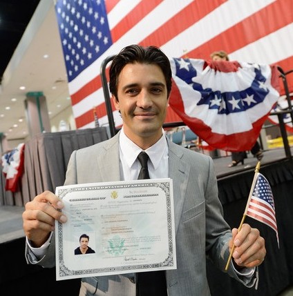 New citizen holds naturalization certificate after applying on the basis of 3 year marriage to a US citizen