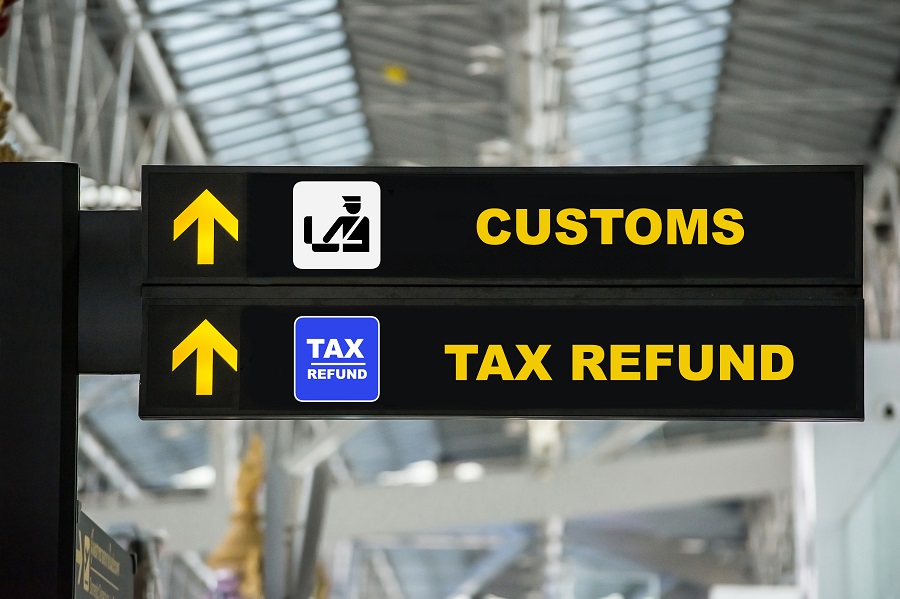 Airport signage with tax terms to start the conversation about your tax resident status