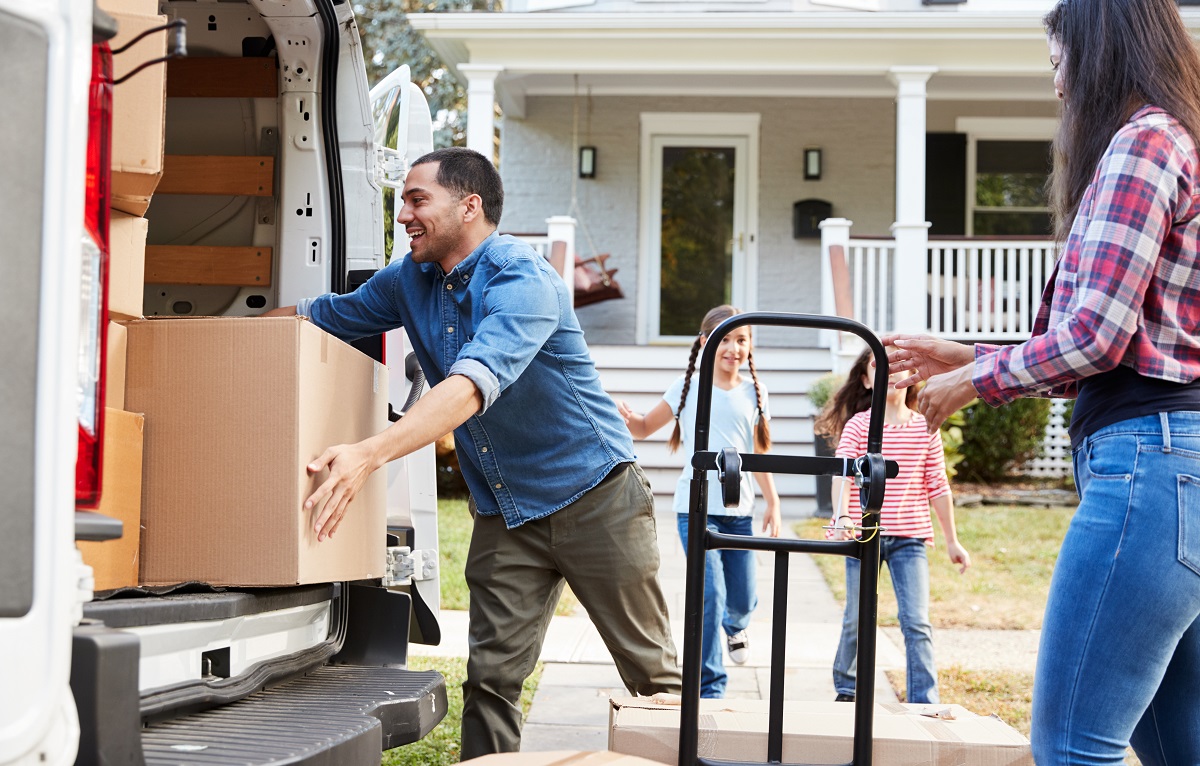 Family loads moving van and prepares USCIS change of address