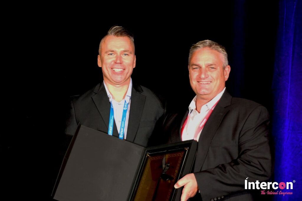 Russ Leimer (right) receives award on behalf of CitizenPath for the company's achievement as a "Top 50 Tech Company" at Intercon Las Vegas 2021