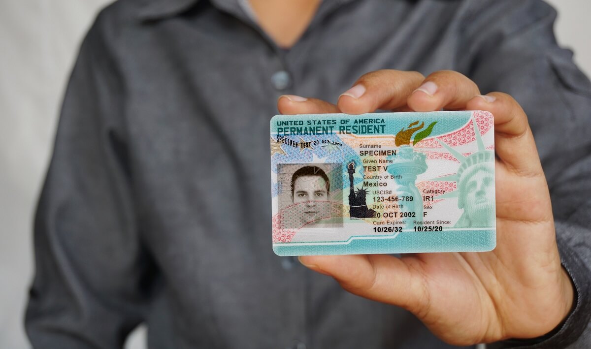Man shows off his green card