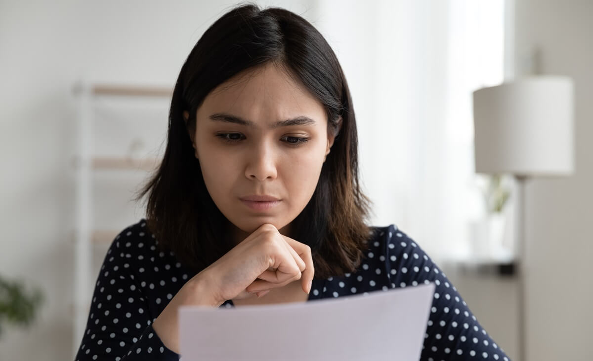 Woman disappointed as she reads adjustment of status denial