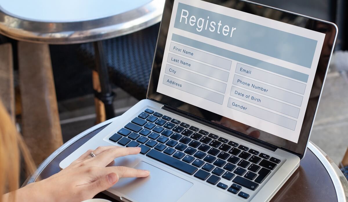 Woman on laptop preparing to begin alien registration requirement with USCIS