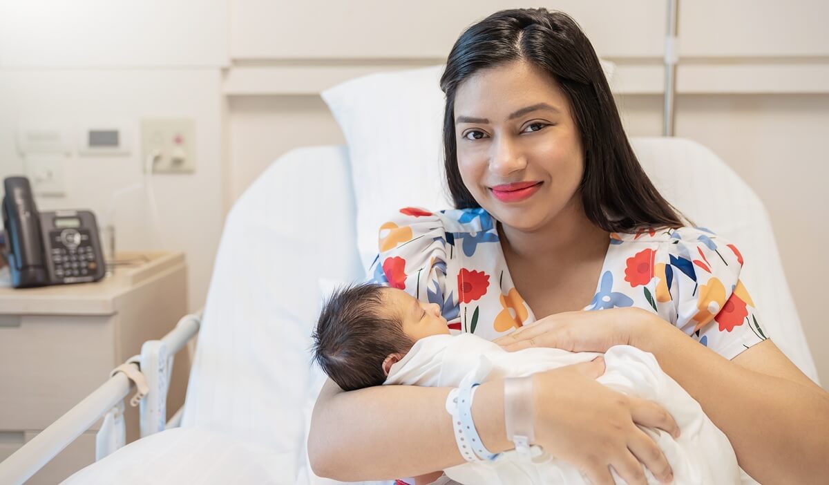 Permanent resident mother holds newborn born abroad