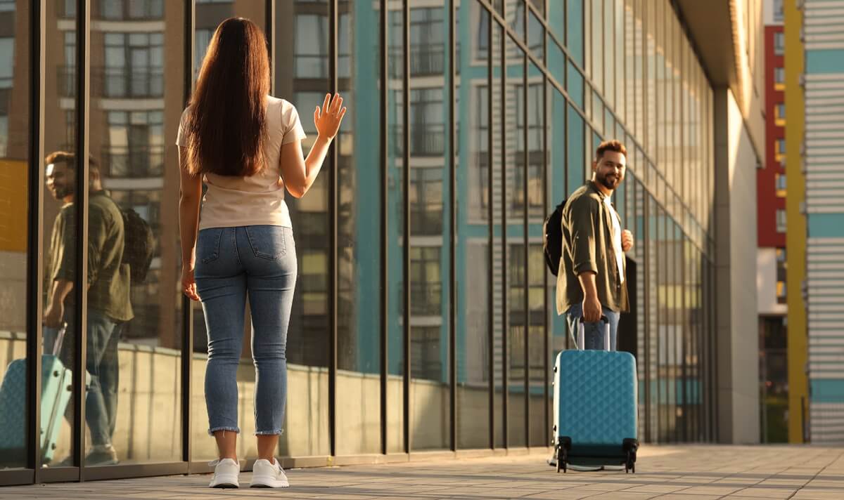 Couple says good-byes at the airport and wonder how to bring a spouse to the US