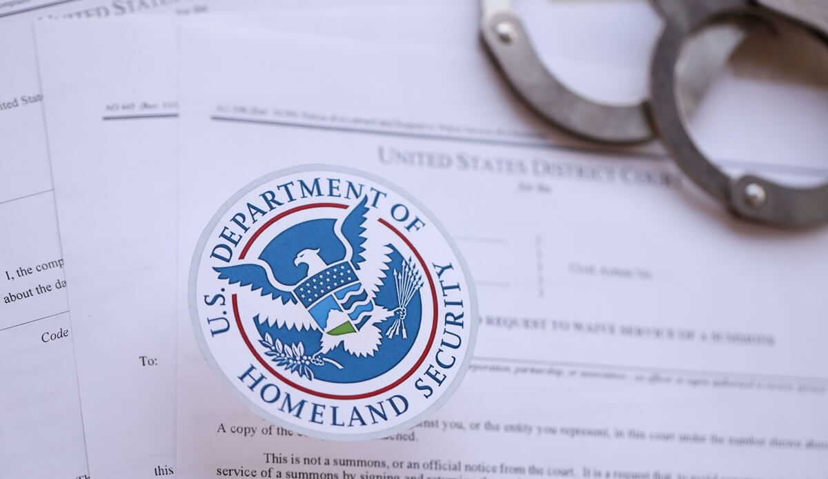 Handcuffs lie on top of DHS documents