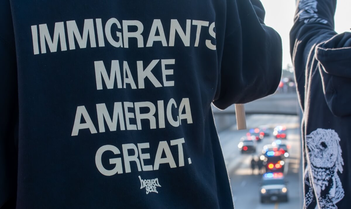 Man wears an "Immigrants Make America Great" t-shirt